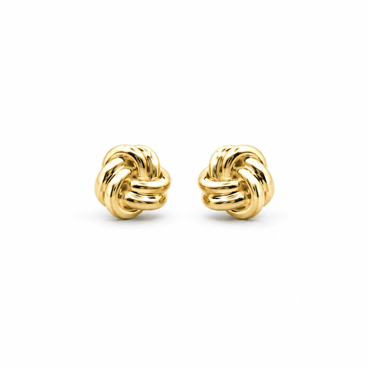 Pair of gold knot earrings on a white background