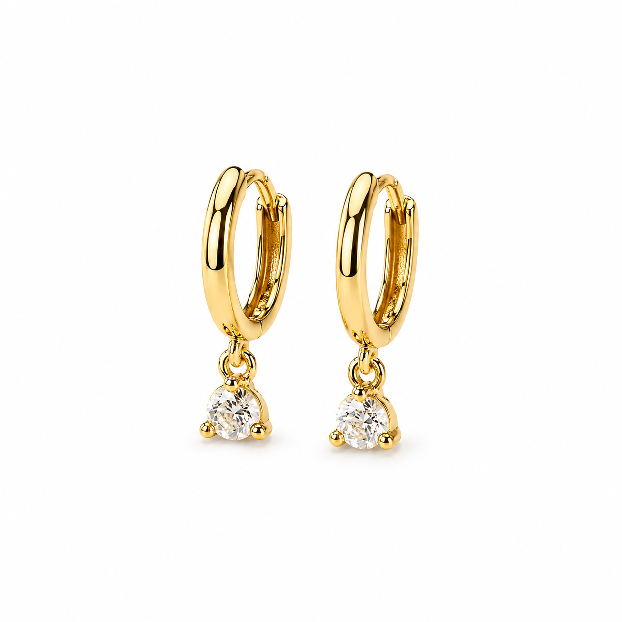 Pair of dainty gold huggie hoop earrings with small dangling round cubic zirconia charms on a clean white background. Minimal and elegant everyday jewelry with a polished gold finish and subtle sparkle.