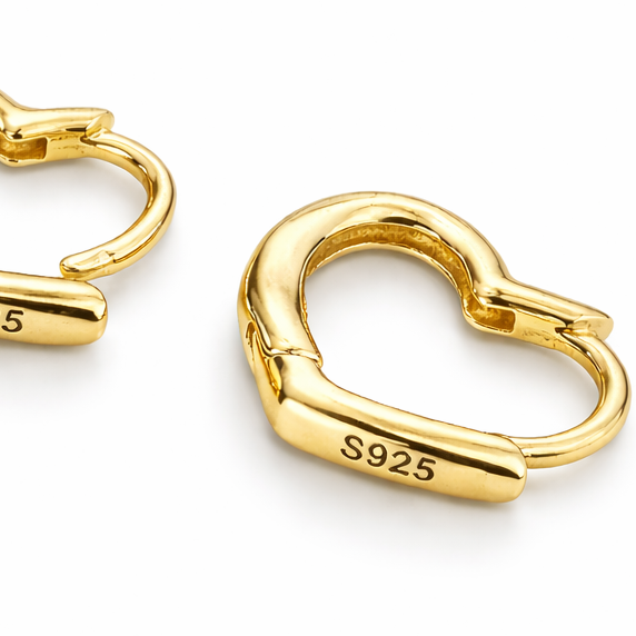 Gold heart-shaped earrings with 'S925' stamp on a white background