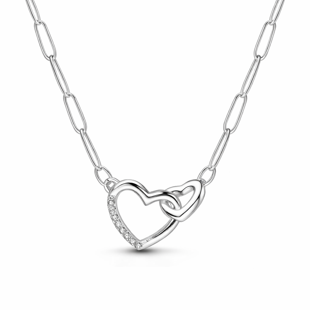 Silver necklace with a heart-shaped pendant with a paperclip chain on a white background 