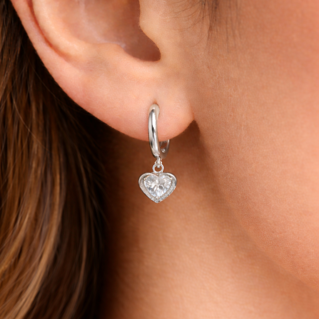 A heart shaped drop hanging on a Hoop earrings as pendant.