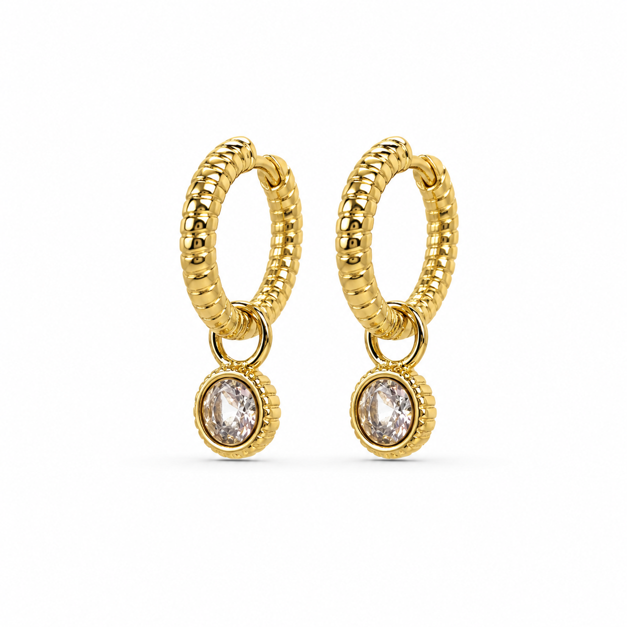 Gold hoop earrings with small round gemstones on a white background