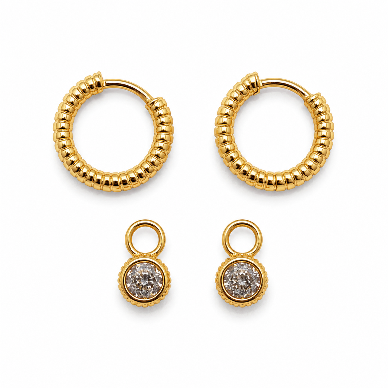Gold hoop earrings and gold earrings with gemstones on a white background